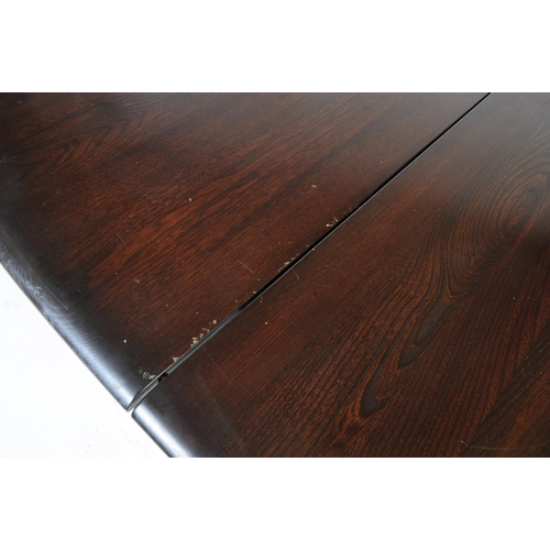 644 - Ercol - Model 705 - A 20th century Ercol Old Colonial elm wood model 705 dining table. The table rai... 