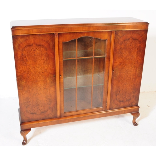 903 - A 20th century circa 1940s Queen Anne revival manner walnut veneer bookcase. The cabinet featuring t... 