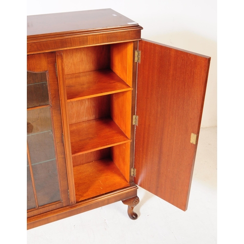 903 - A 20th century circa 1940s Queen Anne revival manner walnut veneer bookcase. The cabinet featuring t... 