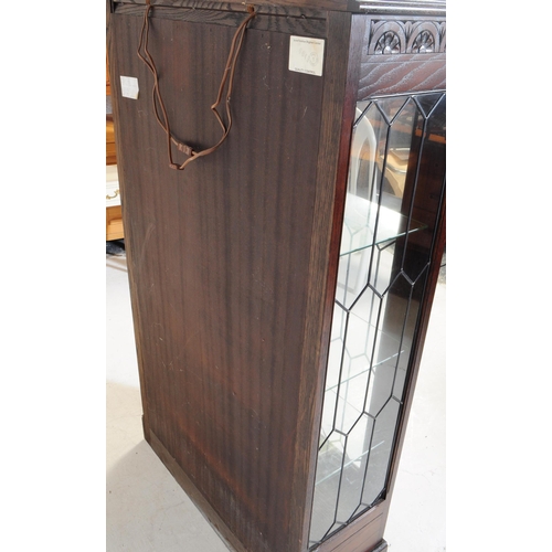 906 - A Jacobean revival oak wood glazed bookcase / display cabinet. The cabinet featuring two doors to fr... 