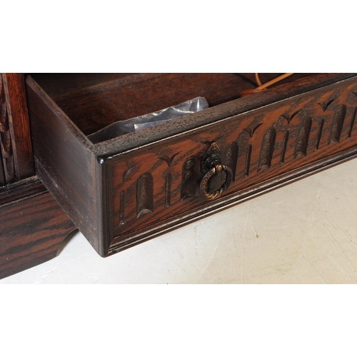 906 - A Jacobean revival oak wood glazed bookcase / display cabinet. The cabinet featuring two doors to fr... 