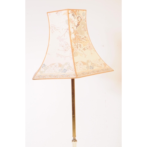 911 - A 20th century Hollywood Regency manner Onyx and Brass style floor standing lamp with shade. The lam... 