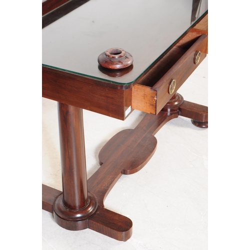 914 - A George III mahogany writing table desk. The desk raised on two thick rounded legs with bun feet, j... 