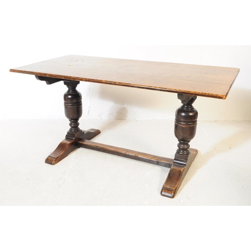 915 - An early 20th century Jacobean revival refectory oak wood dining table and chairs. Raised on two cup... 