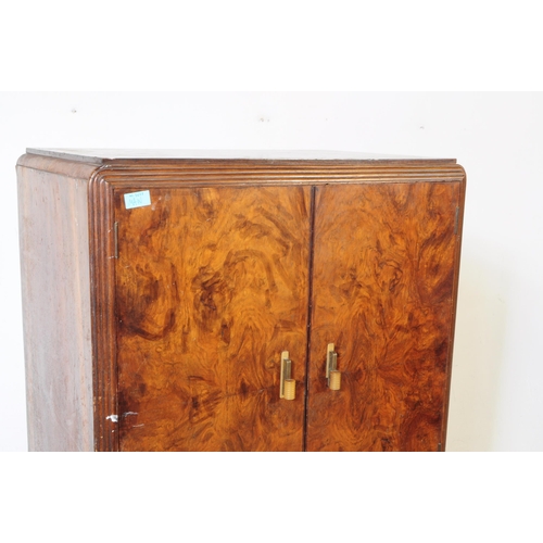 920 - A 20th century circa 1930s Art Deco walnut veneer bachelors wardrobe. Raised on a plinth base the wa... 