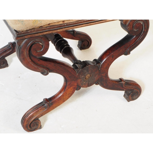 925 - A 19th century Victorian crossed leg mahogany piano stool. The stool having a needlepoint upholstere... 