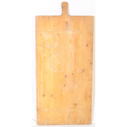 932 - A 19th century French pine wood bread / charcuterie board. The board of large proportions and rectan... 