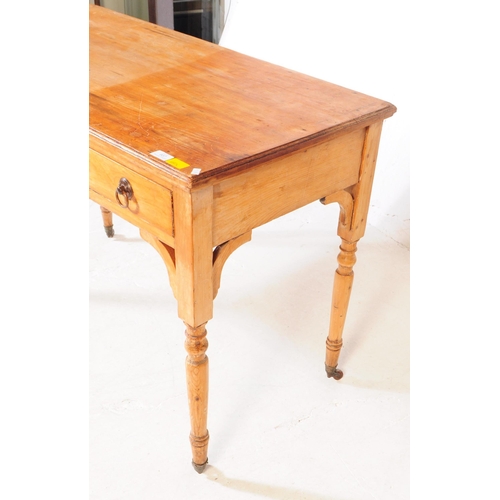 937 - A 19th century Victorian ash / oak wood writing table desk. The desk raised on turned legs terminati... 