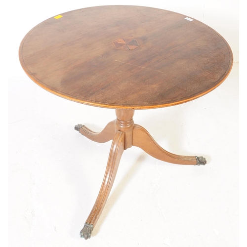 939 - A 19th Century mahogany tilt top loo table. The table raised on splayed tripod legs each terminating... 