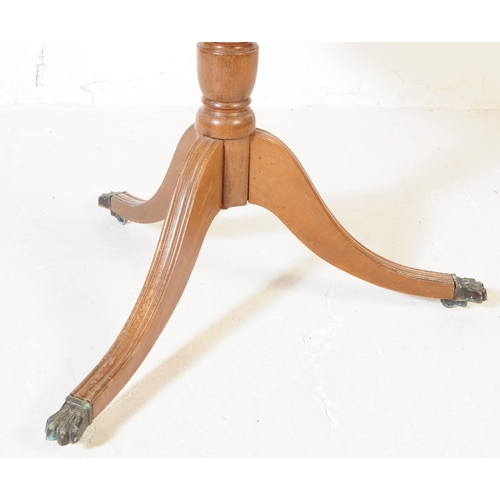 939 - A 19th Century mahogany tilt top loo table. The table raised on splayed tripod legs each terminating... 