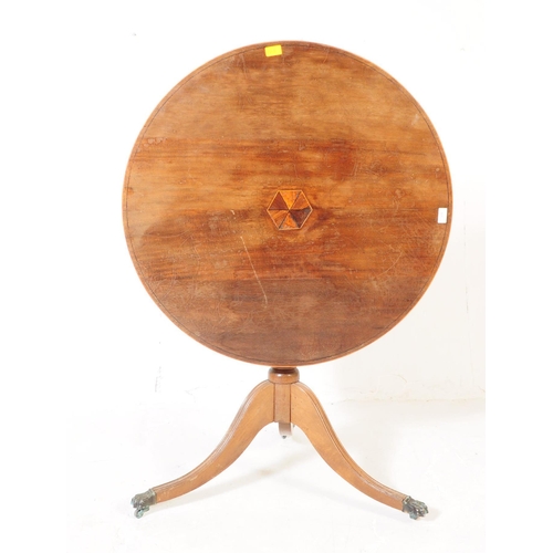 939 - A 19th Century mahogany tilt top loo table. The table raised on splayed tripod legs each terminating... 