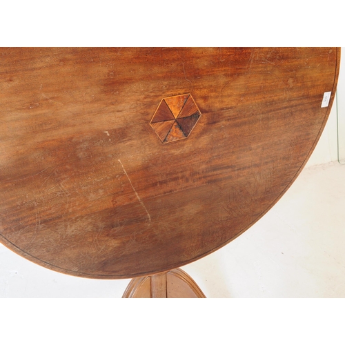 939 - A 19th Century mahogany tilt top loo table. The table raised on splayed tripod legs each terminating... 