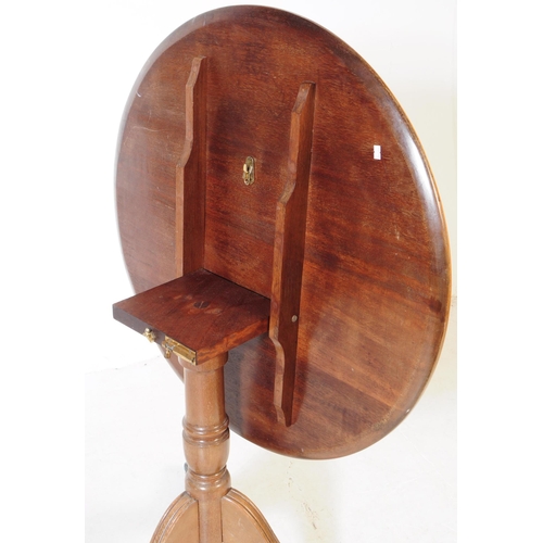 939 - A 19th Century mahogany tilt top loo table. The table raised on splayed tripod legs each terminating... 