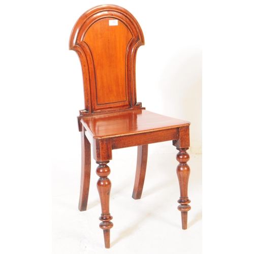 945 - A Victorian 19th century mahogany hall chair being raised on turned legs, with panel seat and armori... 