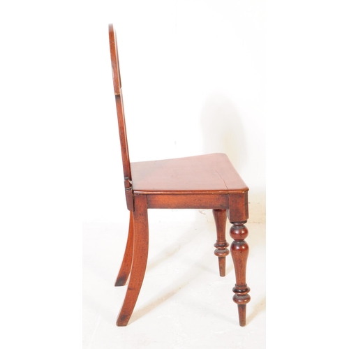 945 - A Victorian 19th century mahogany hall chair being raised on turned legs, with panel seat and armori... 