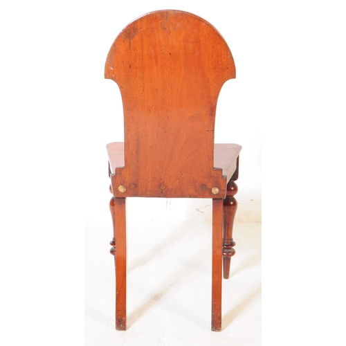 945 - A Victorian 19th century mahogany hall chair being raised on turned legs, with panel seat and armori... 