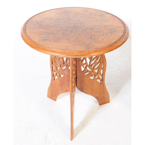 947 - A Moroccan Benares hardwood and brass inlaid opium table. Having pierced Mehrab arches to the octago... 