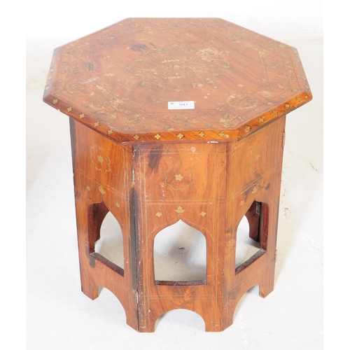 947 - A Moroccan Benares hardwood and brass inlaid opium table. Having pierced Mehrab arches to the octago... 