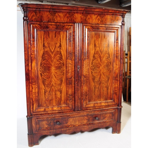 950 - An early 19th century biedermeier (continental) flame mahogany wardrobe armoire. The wardrobe featur... 