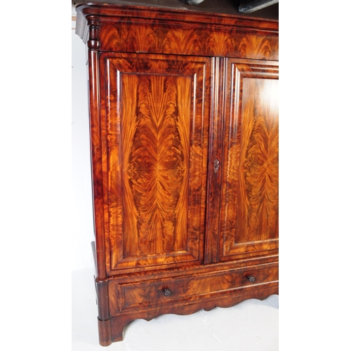 950 - An early 19th century biedermeier (continental) flame mahogany wardrobe armoire. The wardrobe featur... 