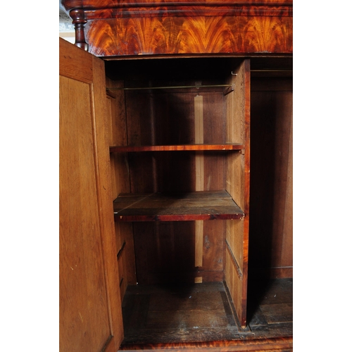 950 - An early 19th century biedermeier (continental) flame mahogany wardrobe armoire. The wardrobe featur... 