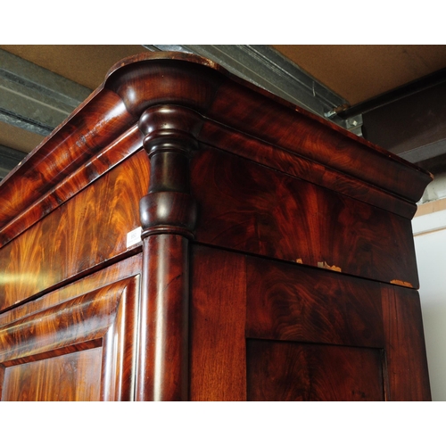 950 - An early 19th century biedermeier (continental) flame mahogany wardrobe armoire. The wardrobe featur... 