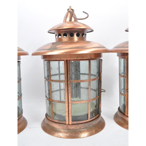 962 - A set of three large 20th Century copper and glass porch lanterns of circular form having copper squ... 