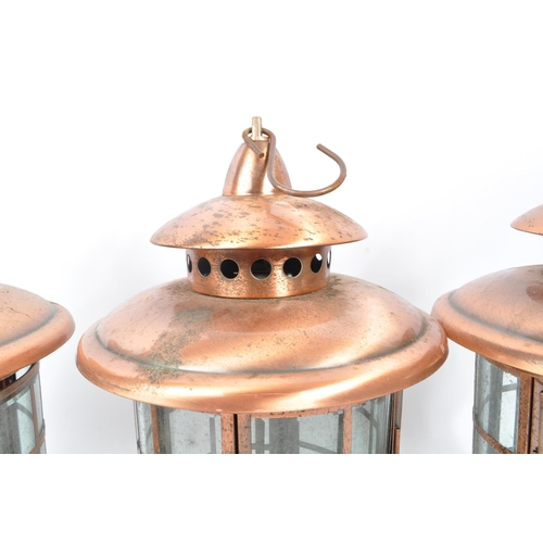 962 - A set of three large 20th Century copper and glass porch lanterns of circular form having copper squ... 