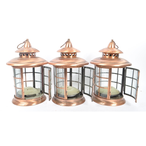 962 - A set of three large 20th Century copper and glass porch lanterns of circular form having copper squ... 