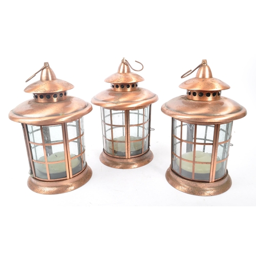 962 - A set of three large 20th Century copper and glass porch lanterns of circular form having copper squ... 