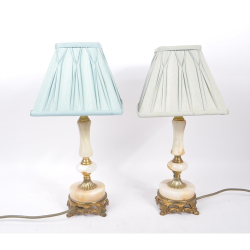 965 - Two 20th Century metal and onyx table lamp / lights having cast brass base upon four feet with onyx ... 