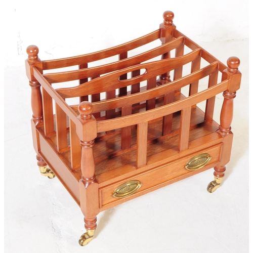 978 - A Canterbury style mahogany magazine rack with drawer, having turned columns and rounded finials. Up... 