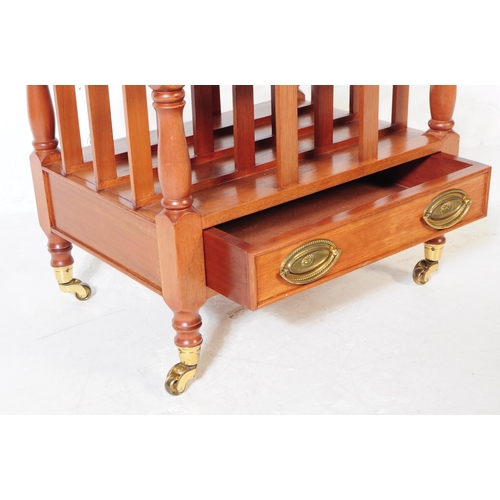 978 - A Canterbury style mahogany magazine rack with drawer, having turned columns and rounded finials. Up... 