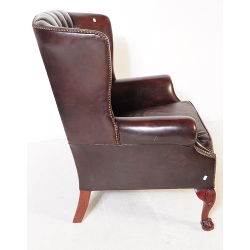 980 - Chesterfield style - A 20th Century brown leather Chesterfield manner wingback armchair. Raised on c... 