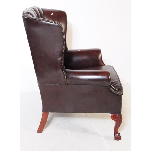 987 - Chesterfield style - A 20th Century brown leather Chesterfield manner wingback armchair. Raised on c... 