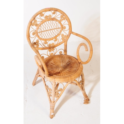 659 - A retro mid 20th century wicker and bamboo conservatory armchair. The chair having a woven cane seat... 