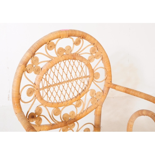 659 - A retro mid 20th century wicker and bamboo conservatory armchair. The chair having a woven cane seat... 