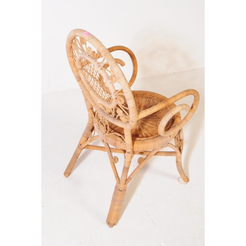 659 - A retro mid 20th century wicker and bamboo conservatory armchair. The chair having a woven cane seat... 