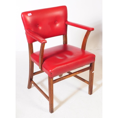 667 - A pair of vintage 20th century red vinyl carver bridge armchairs. Having a back rest on padded cushi... 