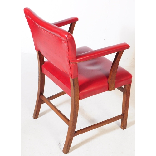 667 - A pair of vintage 20th century red vinyl carver bridge armchairs. Having a back rest on padded cushi... 