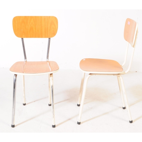 669 - A set of four retro 20th century kitchen / dining chairs. With veneered backrest and seat on a white... 