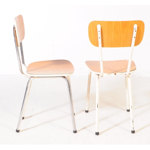 669 - A set of four retro 20th century kitchen / dining chairs. With veneered backrest and seat on a white... 