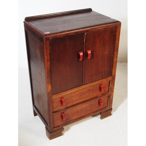 982 - A vintage 20th century circa 1940s Art Deco tallboy oak linen cabinet. Of rectangular form with smal... 