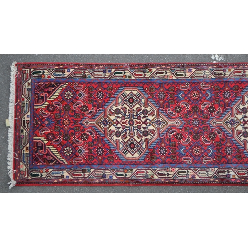 983 - A vintage 20th century Persian Islamic carpet floor runner run. Having geometric repeating pattern w... 