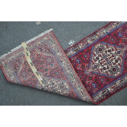 983 - A vintage 20th century Persian Islamic carpet floor runner run. Having geometric repeating pattern w... 