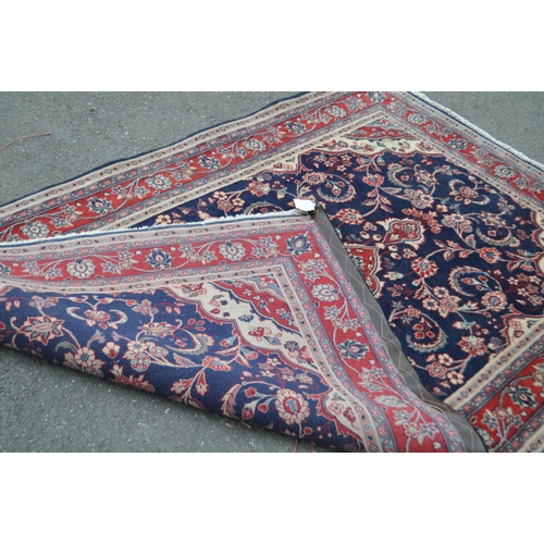 990 - A vintage 20th century North West Persian Sarouk carpet floor rug. Having a red central medallion in... 