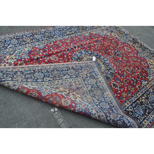 991 - A vintage 20th century Persian Islamic central Najaabad carpet floor rug. With central blue medallio... 