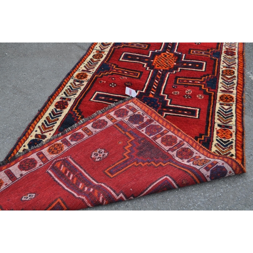 992 - A vintage 20th century South West Persian Lori carpet floor rug. Rectangular form in a red and orang... 