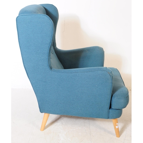 555a - British Modern Design - A contemporary wingback armchair. In a teal colourway with button back desig... 