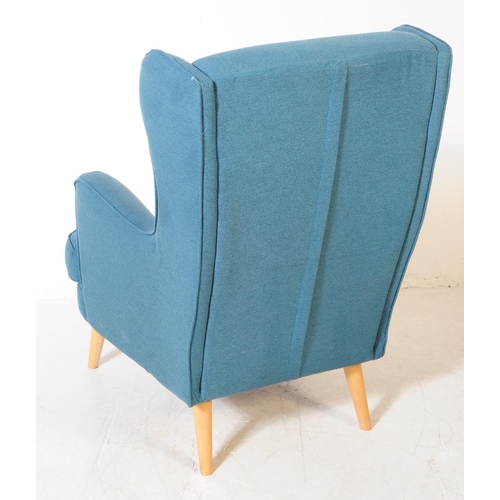 555a - British Modern Design - A contemporary wingback armchair. In a teal colourway with button back desig... 